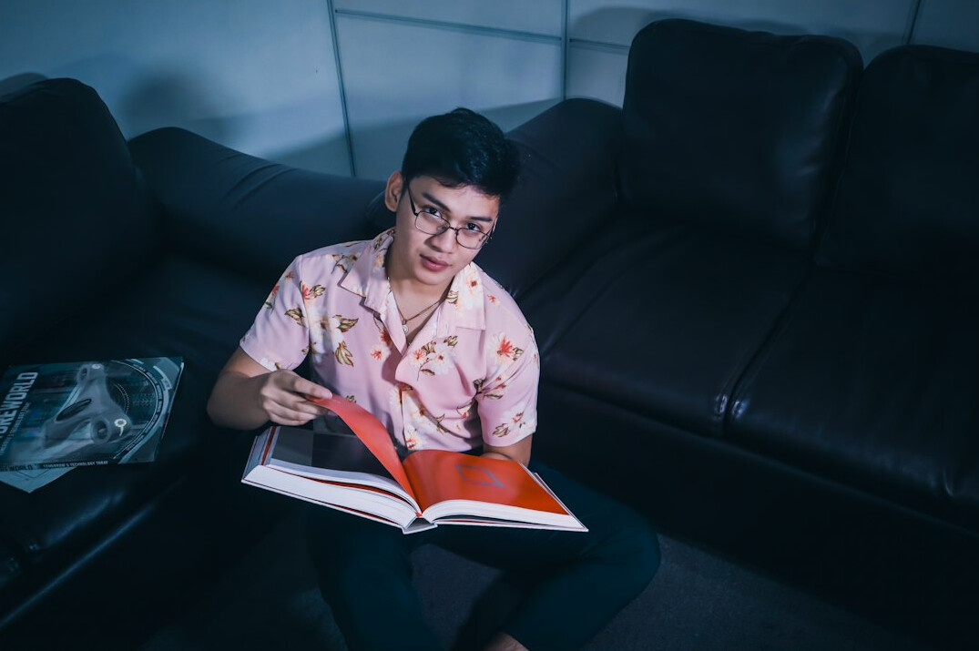 woman reading book at night